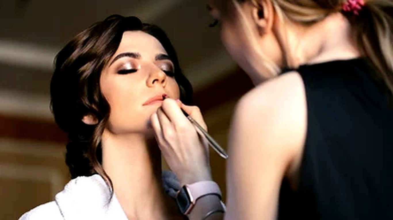 Close-up of bridal makeup artist working on elegant bridal eye makeup