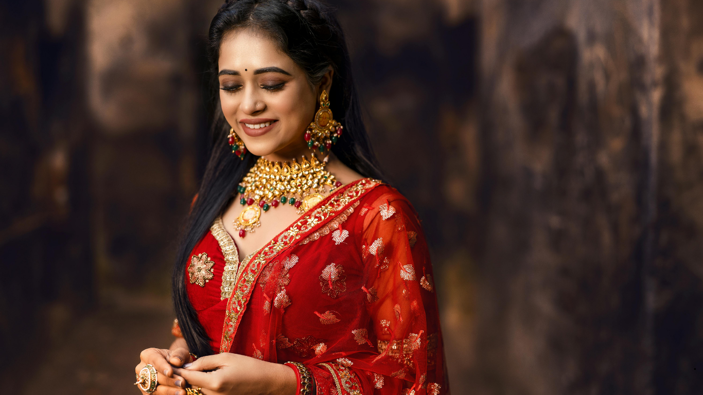 North Indian bridal makeup with bold eyes and red lehenga