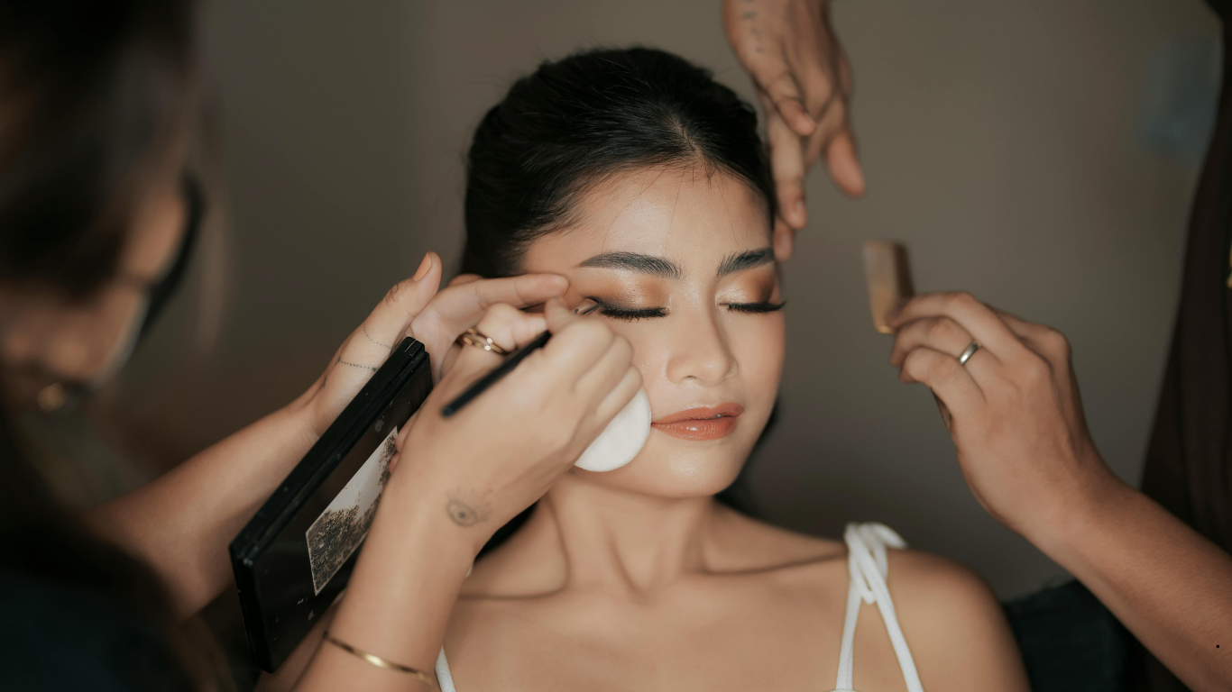 Bridal makeup artist applying eyeliner with precision