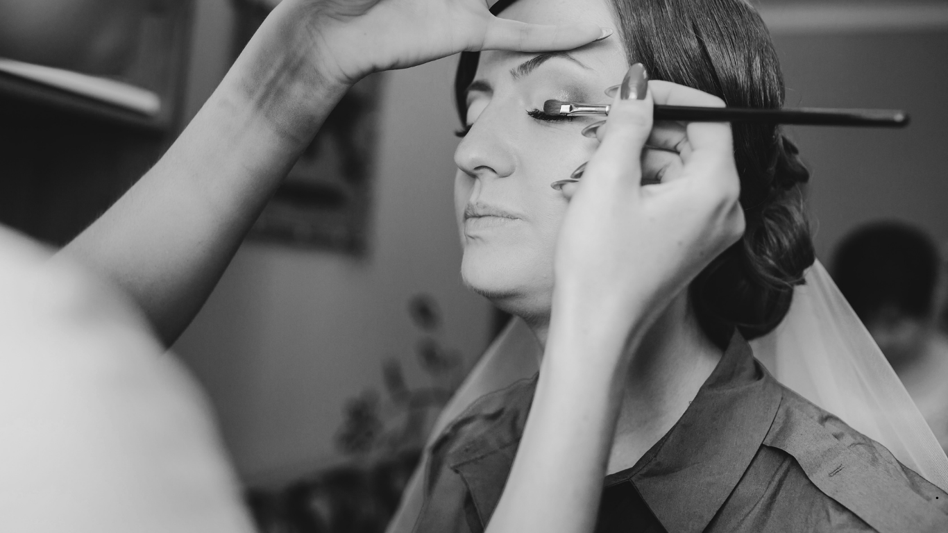 Professional bridal makeup artist creating soft glam look