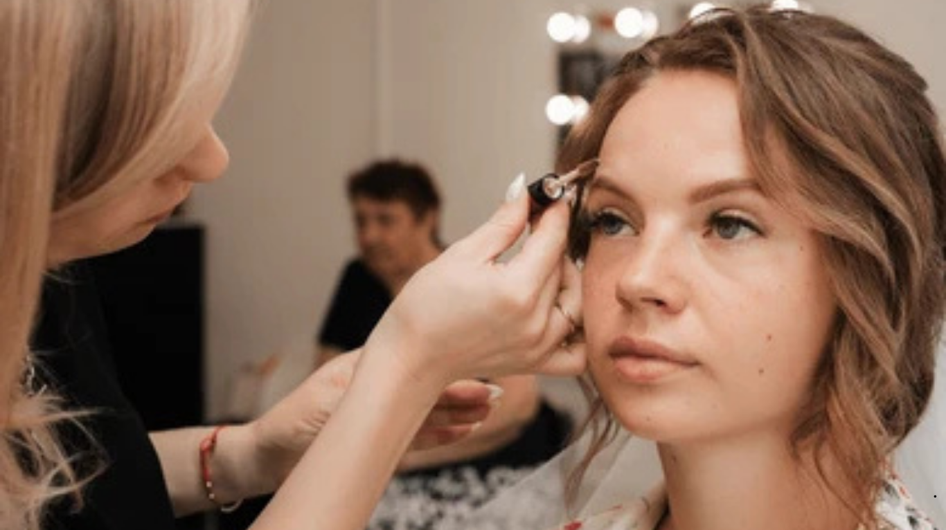 Bridal makeup artist working on bride before wedding